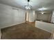 Open floor plan with carpeted and hardwood flooring, modern light fixture, and natural lighting at 11306 E Colorado Dr, Aurora, CO 80012
