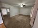 A cozy living room featuring neutral walls, carpet, and a ceiling fan at 11306 E Colorado Dr, Aurora, CO 80012