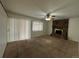 Cozy living room featuring a stone fireplace, carpet, and natural lighting at 11306 E Colorado Dr, Aurora, CO 80012