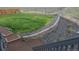 Landscaped backyard with a retaining wall, lush green lawn, and decorative gravel areas at 2404 Horse Shoe Cir, Fort Lupton, CO 80621