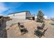 Spacious backyard area with terraced landscaping and a charming fire pit seating area at 2404 Horse Shoe Cir, Fort Lupton, CO 80621