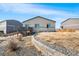 Backyard view featuring a deck, landscaped area, and neighboring homes at 2404 Horse Shoe Cir, Fort Lupton, CO 80621