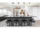 Finished basement featuring an elegant home bar with four stools and bar decor at 2404 Horse Shoe Cir, Fort Lupton, CO 80621