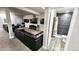 Spacious finished basement with a plush leather couch and modern entertainment setup, adjacent to renovated bathroom at 2404 Horse Shoe Cir, Fort Lupton, CO 80621