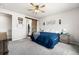 Cozy bedroom with a barn-style sliding door and neutral decor for a serene retreat at 2404 Horse Shoe Cir, Fort Lupton, CO 80621