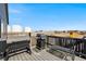 Back deck with multiple grills and seating overlooking a serene view, perfect for outdoor living at 2404 Horse Shoe Cir, Fort Lupton, CO 80621