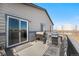 Back deck featuring sliding glass doors and multiple grills, perfect for outdoor entertaining at 2404 Horse Shoe Cir, Fort Lupton, CO 80621