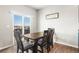 Inviting dining area featuring natural light and a sliding door leading to an outdoor deck at 2404 Horse Shoe Cir, Fort Lupton, CO 80621
