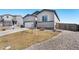 View of the home's front facade and side yard with a fenced property line at 2404 Horse Shoe Cir, Fort Lupton, CO 80621