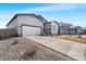 Wide driveway leads to a two-car garage of the house with meticulous landscaping at 2404 Horse Shoe Cir, Fort Lupton, CO 80621