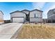 Charming single-story home with a two-car garage and well-maintained front yard at 2404 Horse Shoe Cir, Fort Lupton, CO 80621