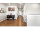 Inviting hallway with warm wood floors, decor and a cabinet featuring a wine rack at 2404 Horse Shoe Cir, Fort Lupton, CO 80621