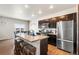 Modern kitchen with stainless steel appliances, central island and wooden stools at 2404 Horse Shoe Cir, Fort Lupton, CO 80621