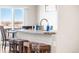 Contemporary kitchen island featuring bar stool seating and a stainless steel faucet at 2404 Horse Shoe Cir, Fort Lupton, CO 80621