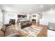 Spacious living area with hardwood floors, comfortable sofas, and an open kitchen at 2404 Horse Shoe Cir, Fort Lupton, CO 80621