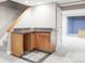 Basement bar area with wooden cabinets, granite counters, and tiled floors at 674 Huntington Dr, Highlands Ranch, CO 80126