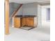 Basement bar area with wooden cabinets, granite counters, and tiled floors at 674 Huntington Dr, Highlands Ranch, CO 80126