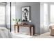 Bedroom detail highlighting a console table, modern art, and lots of natural light from the window at 674 Huntington Dr, Highlands Ranch, CO 80126