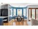 A bright dining area features a blue accent wall, modern light fixture, and wood floors that connect to the kitchen at 674 Huntington Dr, Highlands Ranch, CO 80126