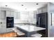 A spacious kitchen featuring a large center island, gray cabinets, modern appliances, and ample counter space at 674 Huntington Dr, Highlands Ranch, CO 80126