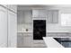 A kitchen featuring gray cabinets, white countertops, stainless steel hardware and a built-in black double oven at 674 Huntington Dr, Highlands Ranch, CO 80126