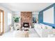 A cozy living room featuring a brick fireplace, plush seating, and an open layout for comfortable living and entertaining at 674 Huntington Dr, Highlands Ranch, CO 80126