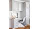 This office nook has gray cabinets, white quartz countertops, drawers, a small workspace, and a white wicker chair at 674 Huntington Dr, Highlands Ranch, CO 80126