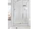 Modern glass enclosed shower with white tile surround and modern fixtures at 674 Huntington Dr, Highlands Ranch, CO 80126