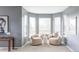 Cozy sitting area with matching chairs, a round side table, and a large bay window for natural light at 674 Huntington Dr, Highlands Ranch, CO 80126
