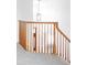 Open staircase with wooden railings and grey carpeted steps; natural light illuminates the hall at 674 Huntington Dr, Highlands Ranch, CO 80126