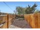 Fenced backyard with mulch and seating area at 1087 Wolff St, Denver, CO 80204
