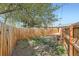 Cozy backyard space featuring a wooden fence, lawn, and mature trees, perfect for relaxing or entertaining at 1087 Wolff St, Denver, CO 80204