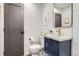 Bathroom with modern fixtures, gold accents, and tiled floors at 1087 Wolff St, Denver, CO 80204