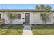 Charming home featuring a white brick facade, well-maintained lawn, and a neatly landscaped front yard at 1087 Wolff St, Denver, CO 80204