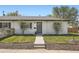 Charming home featuring a white brick facade, well-maintained lawn, and a neatly landscaped front yard at 1087 Wolff St, Denver, CO 80204