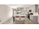 Modern kitchen with stainless steel appliances, gray cabinets, and a stylish island with seating at 1087 Wolff St, Denver, CO 80204