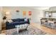Inviting living room featuring stylish decor, a comfortable sofa, and an open layout to the kitchen at 1087 Wolff St, Denver, CO 80204