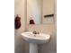 Elegant pedestal sink in a powder room with decorative fixtures at 15612 E 96Th Way # 29A, Commerce City, CO 80022
