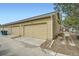 Garages of a home with individual driveways and landscaping at 15612 E 96Th Way # 29A, Commerce City, CO 80022