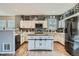 Kitchen with a wooden center island, sleek appliances, and bright lighting at 15612 E 96Th Way # 29A, Commerce City, CO 80022