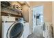 A laundry room with washer, dryer, and open shelving at 15612 E 96Th Way # 29A, Commerce City, CO 80022