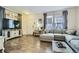 Bright living room with hardwood floors, a TV console, and a comfortable sectional sofa at 15612 E 96Th Way # 29A, Commerce City, CO 80022