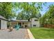 Expansive backyard with a covered patio, outdoor seating, lush lawn, and a charming gravel area for entertaining at 3545 Moorhead Ave, Boulder, CO 80305