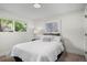 Bright bedroom featuring a large window providing natural light and a comfortable bed with plush pillows at 3545 Moorhead Ave, Boulder, CO 80305