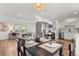 Charming dining room features a table set for four and an open view to the updated kitchen with stainless appliances at 3545 Moorhead Ave, Boulder, CO 80305