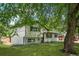 A charming two-story home with a lush green lawn and mature trees at 3545 Moorhead Ave, Boulder, CO 80305