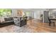 Spacious living room featuring hardwood floors, modern decor, and access to kitchen at 3545 Moorhead Ave, Boulder, CO 80305