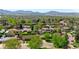 This aerial view displays a suburban neighborhood nestled against a scenic mountain backdrop, perfect for nature enthusiasts at 4779 S Owens Way, Littleton, CO 80127