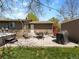 Spacious backyard with a patio, hot tub, and mature trees at 4779 S Owens Way, Littleton, CO 80127