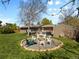 Large backyard features a fire pit area, hot tub, patio dining, mature landscaping, and a shed at 4779 S Owens Way, Littleton, CO 80127